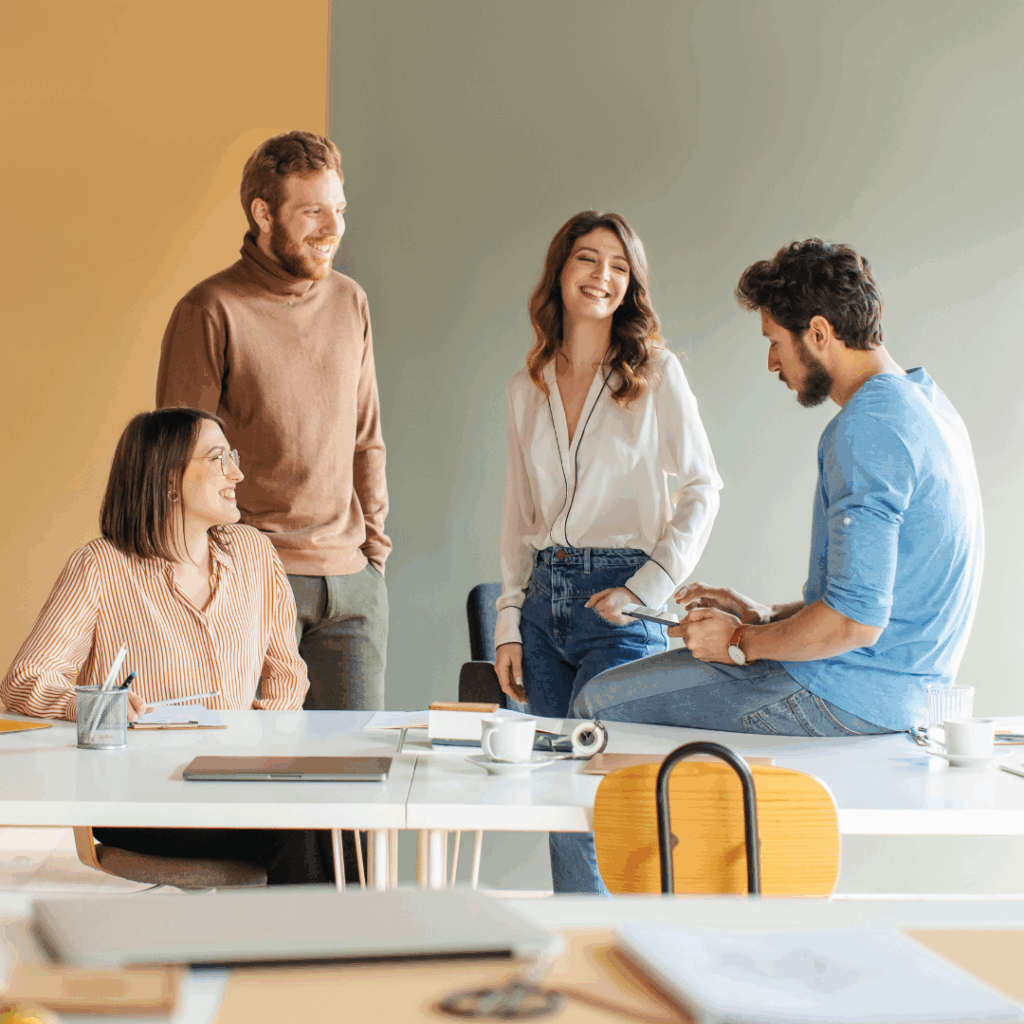 Employees working together around a table, showcasing teamwork and inclusivity at work